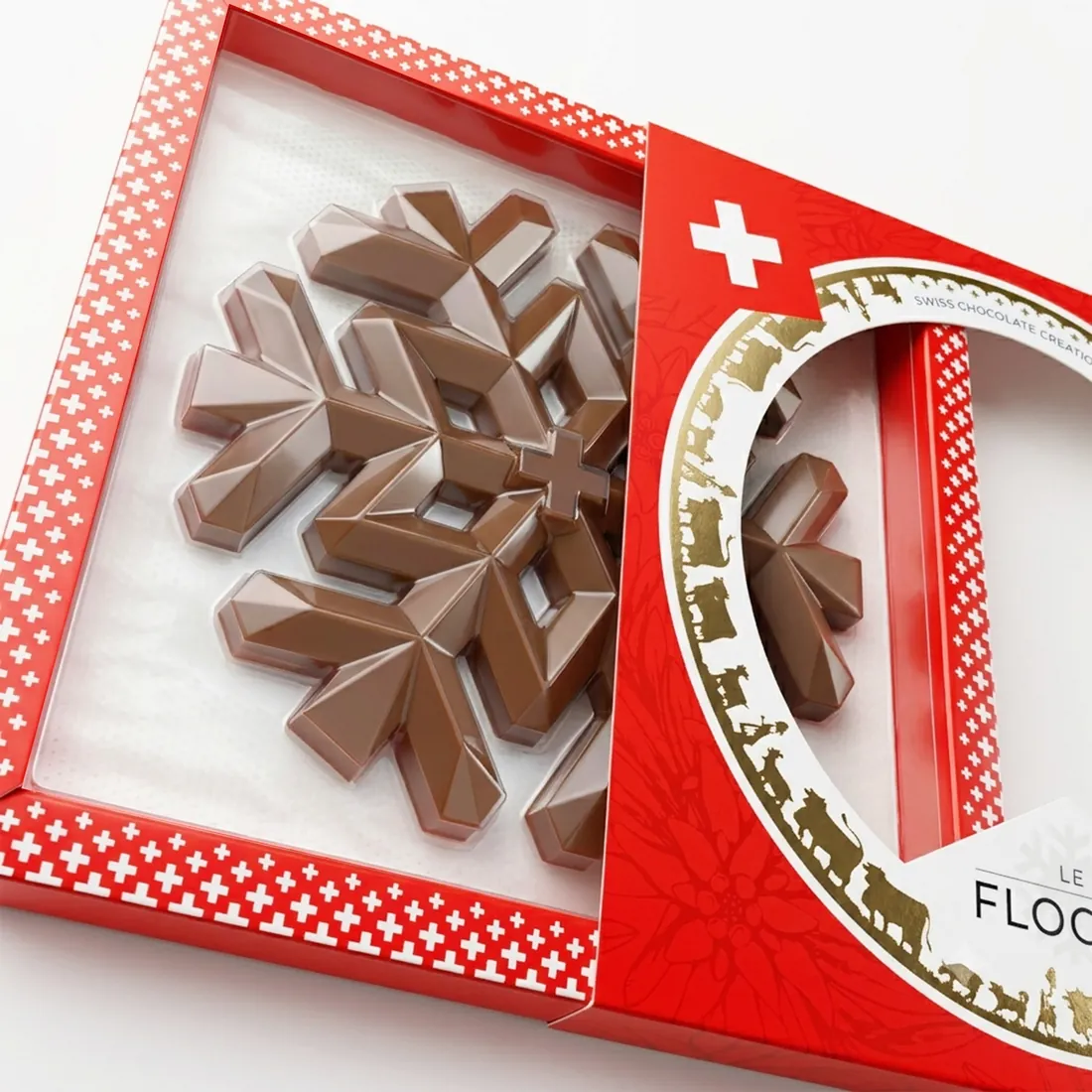 Le coffret du Flocon, fourreau rouge glissé de côté : la pièce au lait entière, dans un cadre à petites croix blanches