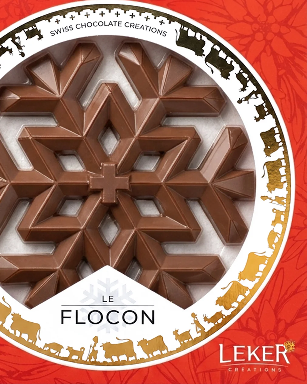 Le coffret rouge du Flocon : la pièce au lait visible par la fenêtre ronde, cerclée d’une frise alpine dorée
